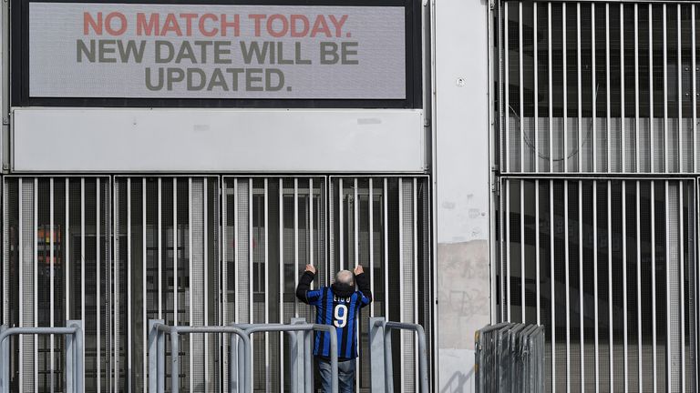 A man stands outside the San Siro stadium after the Inter Milan v Sampdoria Serie A match was cancelled due to an outbreak of the coronavirus in Lombardy and Veneto, in Milan, Italy, February 23, 2020