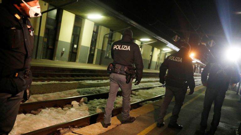 Italian police officers are seen inside the Brennero-Brenner train station in Italy after the train left, February 23, 2020. REUTERS/Leonhard Foeger