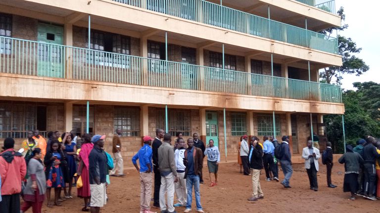 Parents and teachers gather near the scene of a stampede at Kakamega primary school