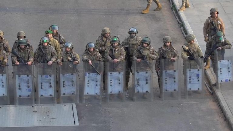 Security personnel prepare to combat protestors