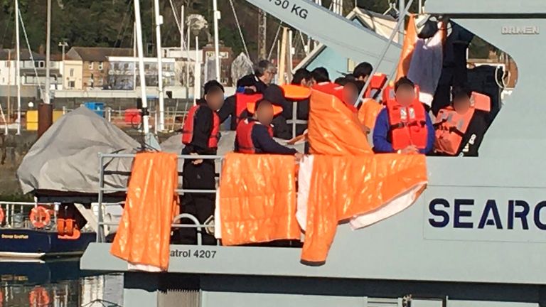 Migrants are brought ashore on the Border Force vessel Searcher in Dover