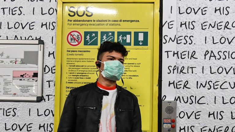 A man wearing a respiratory mask looks on in the subway, in Milan, on February 23, 2020. - Tens of thousands of Italians prepared for a weeks-long quarantine in the country's north on February 23 as nerves began to fray among the locals faced with new lockdown measures