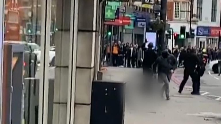 Police move away from terror suspect on pavement in Streatham