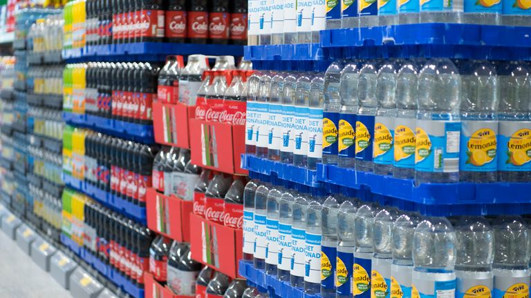 Supermarket shelves stacked with drinks
