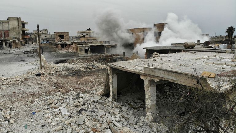 An aerial view shows smoke billowing from a building in the village of Maaret al-Naasan in Syria&#39;s Idlib province on February 12, 2020 following a weeks-long regime offensive against the country&#39;s last major rebel bastion. - Syrian regime forces pushed on with their offensive in the country&#39;s northwest, securing areas along a key national highway they seized, as tensions spiralled with Turkey which supports rebel groups. (Photo by Omar HAJ KADOUR / AFP) (Photo by OMAR HAJ KADOUR/AFP via Getty Im