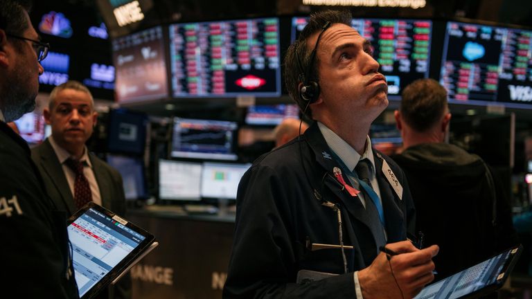 Traders work through the closing minutes of trading Tuesday on the New York Stock Exchange floor on February 25, 2020 in New York City