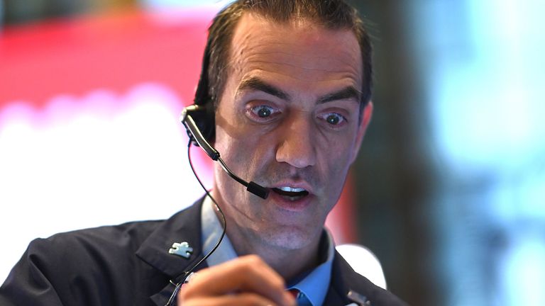 Traders work during the opening bell at the New York Stock Exchange (NYSE) on February 27, 2020 at Wall Street in New York City. 