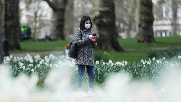 A woman wearing a face mask in Green Park, London, as the UK's coronavirus death toll rose to 35 with a total of 1,372 positive tests for coronavirus in the UK as of 9am on Sunday.