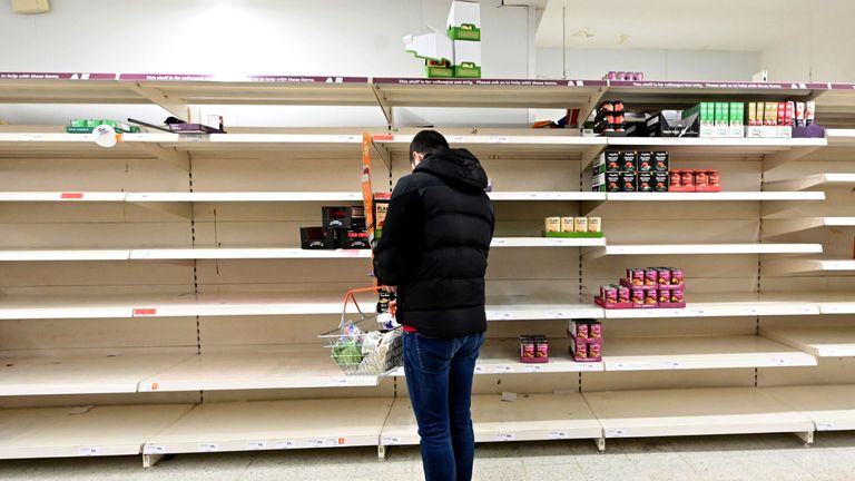 Shoppers are faced with partially empty shelves at a supermarket in London on March 14, 2020, as consumers worry about product shortages, leading to the stockpiling of household products due to the outbreak of the novel coronavirus COVID-19. - British Prime Minister Boris Johnson, who has faced criticism for his country's light touch approach to tackling the coronavirus outbreak, is preparing to review its approach and ban mass gatherings, according to government sources Saturday. (Photo by JUSTIN TALLIS / AFP) (Photo by JUSTIN TALLIS/AFP via Getty Images)