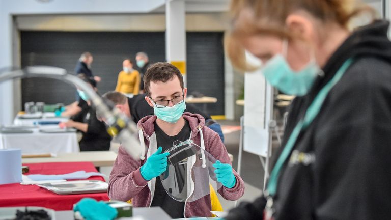 Royal Mint employees assemble full face visors in the cafe inside the Royal Mint Experience, where workers, who usually mint coins at the Royal Mint, Llantrisant, Wales, are now making face visors to supply NHS staff to help get PPE to health workers.