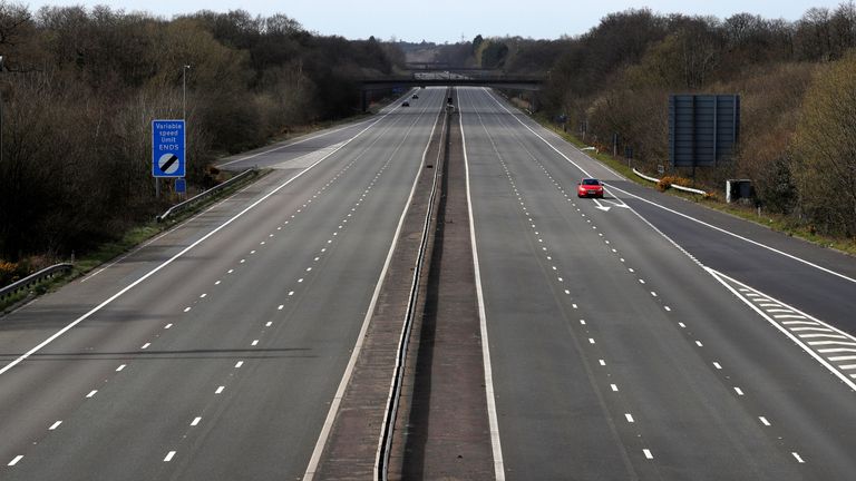 A car travels along the almost deserted M3 motorway near Fleet, south west of London on March 29, 2020, as life in Britain continues during the nationwide lockdown to combat the novel coronavirus pandemic. - Prime Minister Boris Johnson warned Saturday the coronavirus outbreak will get worse before it gets better, as the number of deaths in Britain rose 260 in one day to over 1,000. The Conservative leader, who himself tested positive for COVID-19 this week, issued the warning in a leaflet being sent to all UK households explaining how their actions can help limit the spread. "We know things will get worse before they get better," Johnson wrote. (Photo by Adrian DENNIS / AFP) (Photo by ADRIAN DENNIS/AFP via Getty Images)