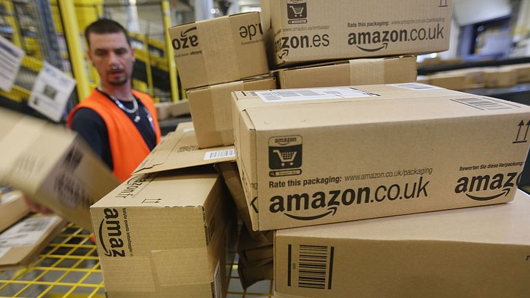 BRIESELANG, GERMANY - SEPTEMBER 04: A worker prepares packages for delivery at an Amazon warehouse on September 4, 2014 in Brieselang, Germany. Germany is online retailer Amazon&#39;s second largest market after the USA. Amazon is currently in a standoff with several book publishers over sales conditions and prices for e-books, and hundreds of authors in the US and Europe have written letters in support of the publishers. (Photo by Sean Gallup/Getty Images)
