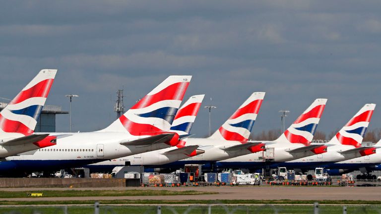 This picture shows British Airways planes grounded at Heathrow&#39;s airport terminal 5, in west London, on March 16, 2020. - IAG, the owner of British Airways and Spanish carrier Iberia, said Monday it would slash the group&#39;s flight capacity by 75 percent during April and May owing to the coronavirus outbreak. "For April and May, the Group plans to reduce capacity by at least 75 percent compared to the same period in 2019," it said in a statement. (Photo by Adrian DENNIS / AFP) (Photo by ADRIAN DEN