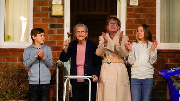 Barbara Leigh, aged 93 rings a bell for the NHS with her family - across the road from Wythenshawe Hospital in Manchester