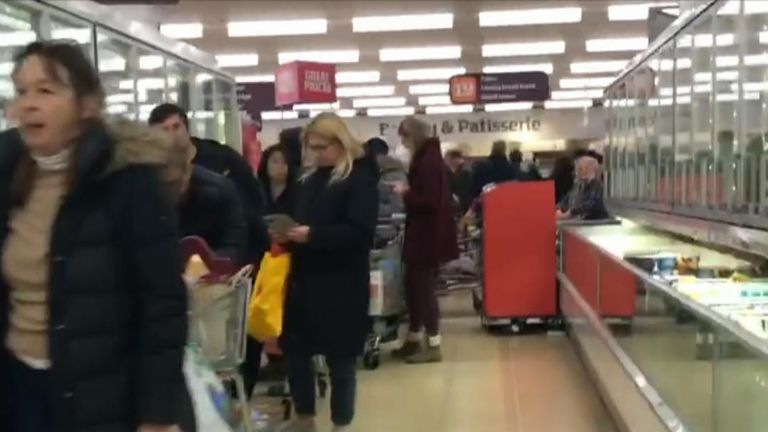 Queues at supermarkets stretch through aisles