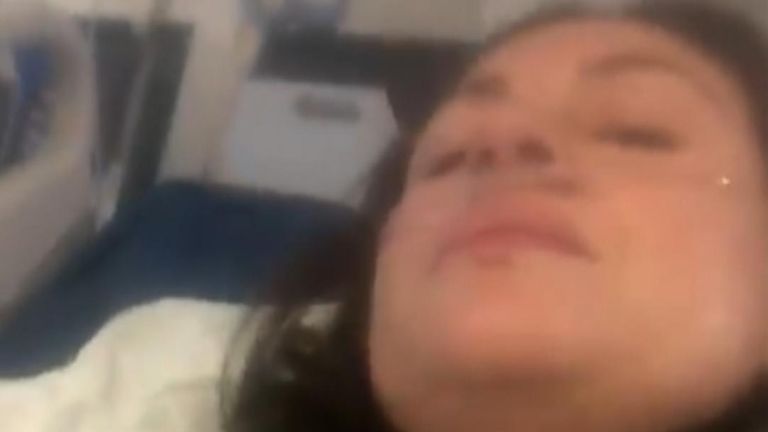 A video showing a hospitalized woman suffering from COVID-19 symptoms and urging viewers to be cautious regarding their health has gone viral.