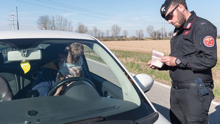 Military police check documents at a 'red zone' checkpoint in San Fiorano, southeast of Milan