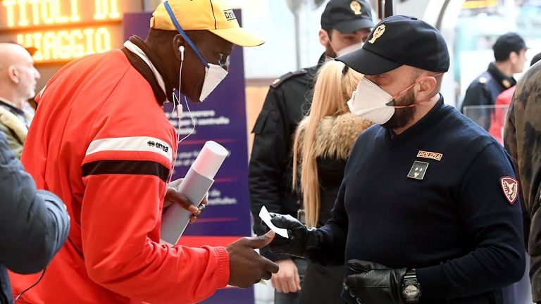 Police officers make checks at Milan's main train station