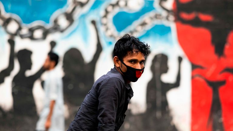 A rickshaw driver wears a face mask in Bangladesh