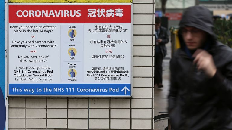 A sign directs patients towards an NHS 111 coronavirus (COVID-19) pod at St Thomas&#39; Hospital in London 
