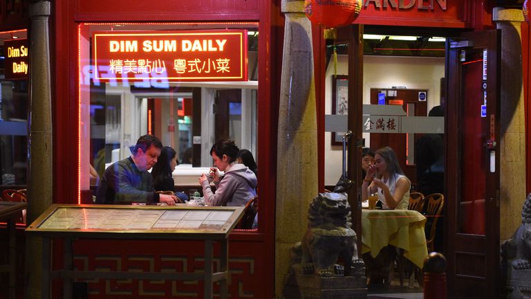 Customers enjoy a meal in a restaurant in London&#39;s Chinatown