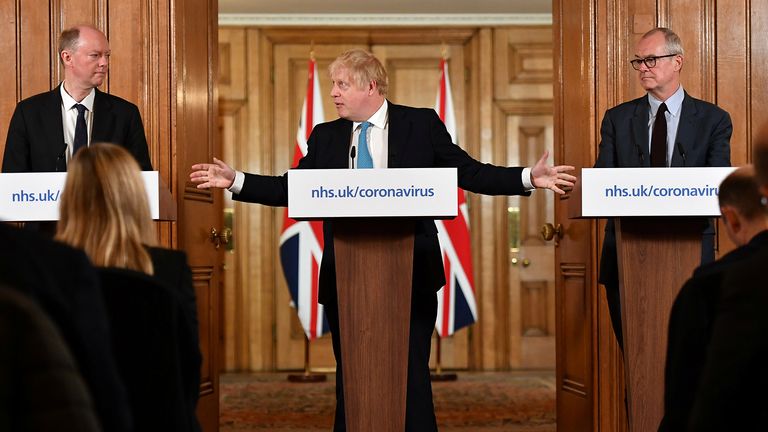 Britain&#39;s Chief Medical Officer Professor Chris Whitty (L) and Chief Scientific Adviser Patrick Vallance  look on as British Prime Minister Boris Johnson gestures as he speaks during a coronavirus disease (COVID-19) news conference inside 10 Downing Street, London, Britain March 19, 2020.  Leon Neal/Pool via REUTERS