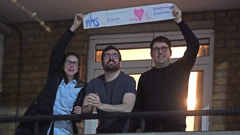 People clap from a block of flats opposite St Thomas&#39; Hospital in London. Pic: Facundo Arrizabalaga/EPA-EFE/Shutterstock 