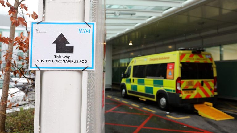 A sign directs patients towards an NHS 111 coronavirus pod at a UK hospital.
