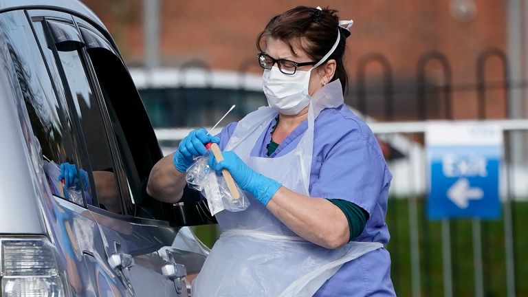 WOLVERHAMPTON, ENGLAND - MARCH 12: A member of the public is swabbed at a drive through Coronavirus testing site, set up in a car park, on March 12, 2020 in Wolverhampton, England. The National Health Service facility has been set up in a car park to allow people with NHS referrals to be swabbed for Covid-19. (Photo by Christopher Furlong/Getty Images)