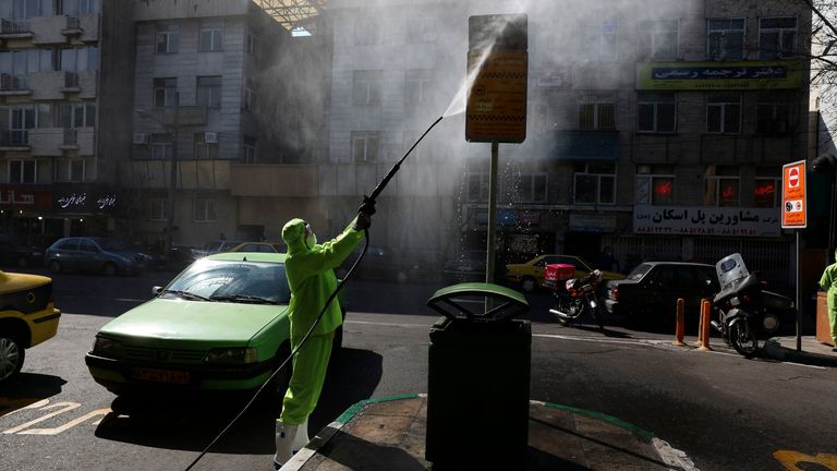 A city worker disinfects a bus stop sign because of the new coronavirus in Tehran, Iran, Thursday, March 5, 2020. Iran has one of the highest death tolls in the world from the new coronavirus outside of China, the epicenter of the outbreak. (AP Photo/Vahid Salemi)