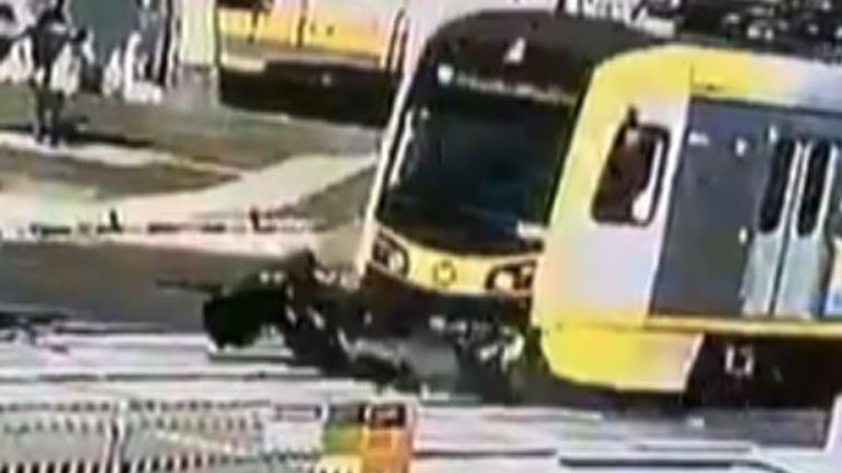 Car is destroyed by train as it crosses tracks - but driver survives with a few bruises