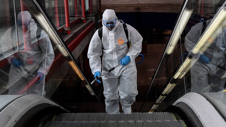 A member of the Military Emergencies Unit (UME) carries out a general disinfection at the Nuevos Ministerios Metro Station in Madrid 