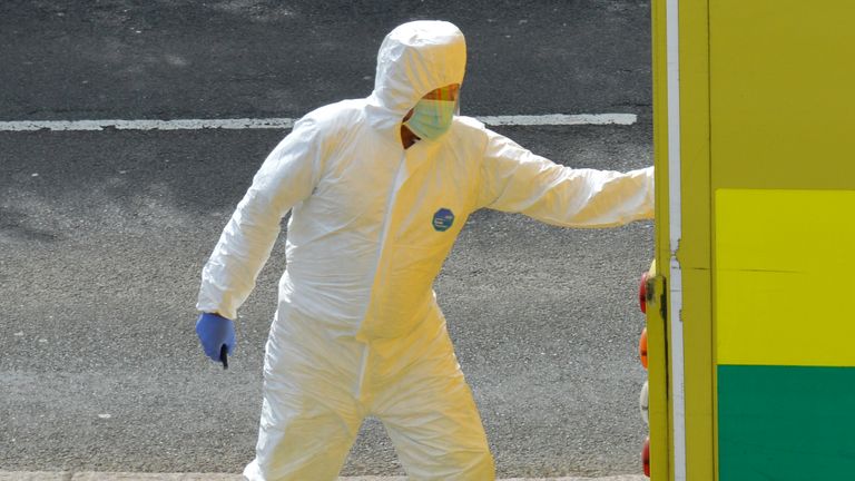 A paramedic is seen wearing a protective face mask 