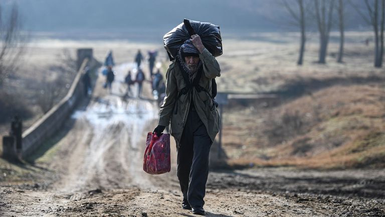 A migrant walks toward the Meritsa river near Edirne in northwest Turkey