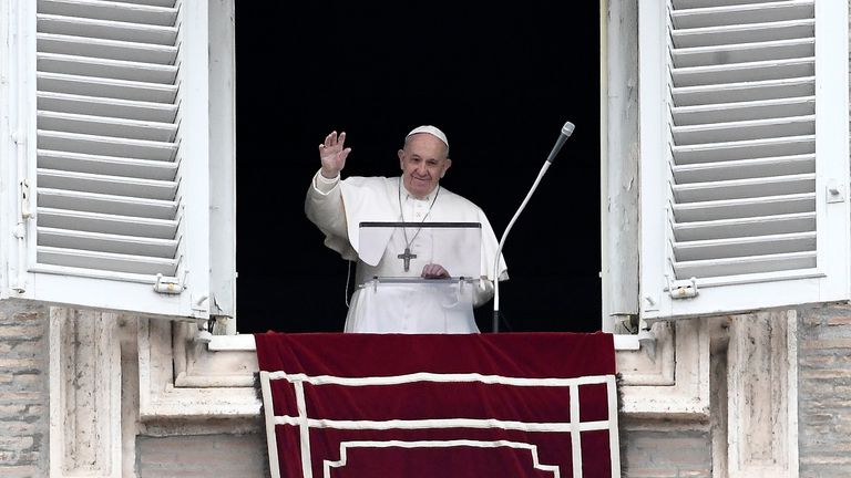 Pope Francis waves to the faithfuls from his studio window overlooking Saint Peter&#39;s Square