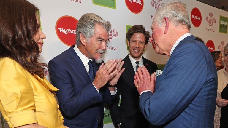 LONDON, ENGLAND - MARCH 11: Prince Charles, Prince of Wales uses the Namaste gesture to greet Anna Friel and Pierce Brosnan as he attends the Prince's Trust And TK Maxx & Homesense Awards at London Palladium on March 11, 2020 in London, England. (Photo by Yui Mok - WPA Pool/Getty Images)