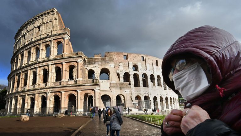 A tourist wears a face mask in Rome