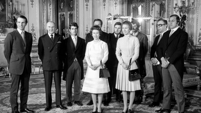 Russell (far right) received his medal from the Queen at Buckingham Palace