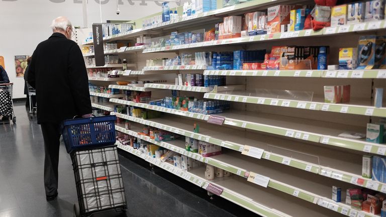 A man with a shopping trolley at a Sainsbury&#39;s