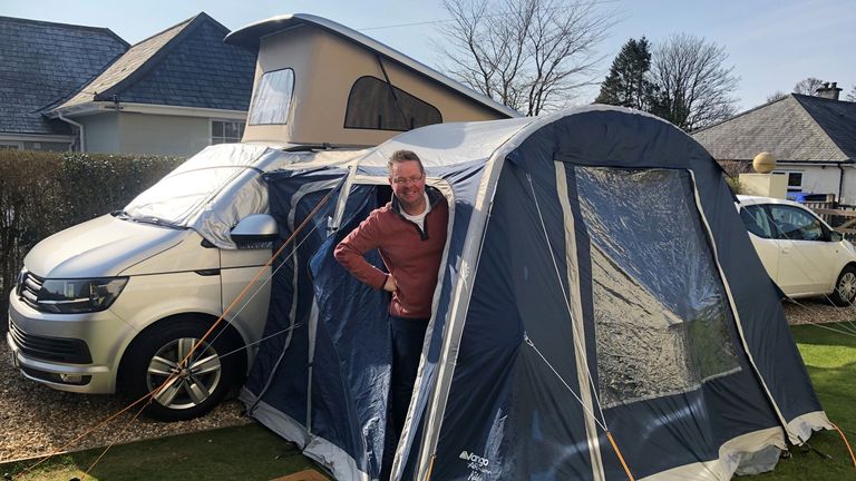 Simon Cowls sleeps in the pullout tent of his campervan to sheild himself from society