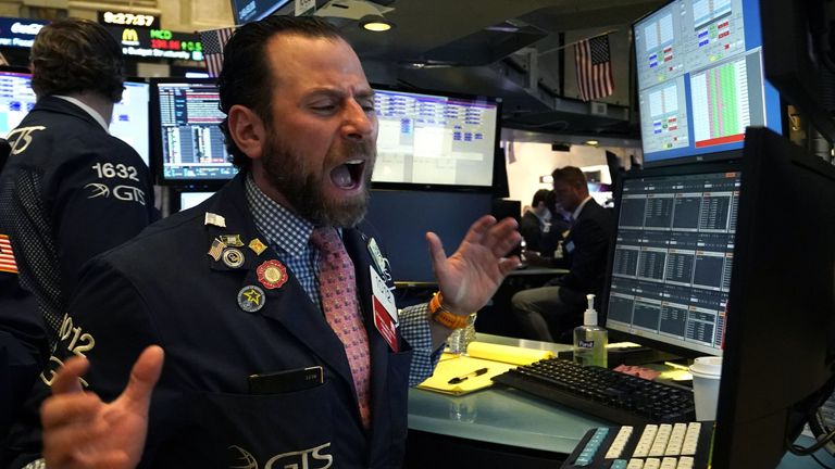 A trader reacts as he works on the floor during the opening bell on the New York Stock Exchange on March 9, 2020 in New York. - Trading on Wall Street was temporarily halted early March 9, 2020 as US stocks joined a global rout on crashing oil prices and mounting worries over the coronavirus.The suspension was triggered after the S&P 500&#39;s losses hit seven percent. Near 1340 GMT, the broad-based index was down more than 200 points at 2,764.21