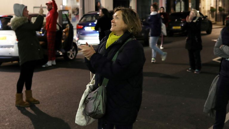 Dr Olivera Potparic, an anaesthetist originally from Serbia, applauds her colleagues after finishing a 12 hour shift