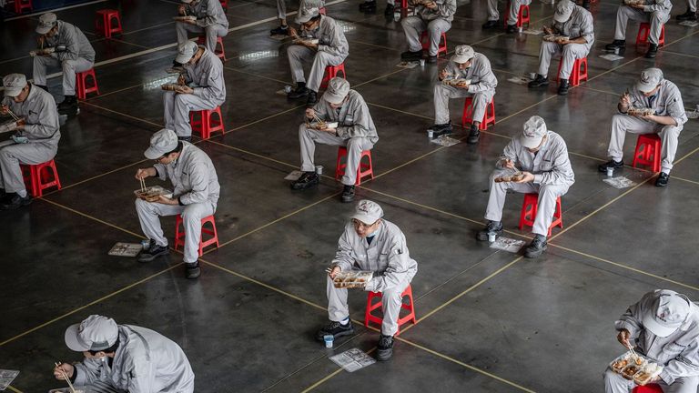 Employees at Dongfeng Honda's auto plant in Wuhan were back at work on Monday but still ate lunch apart