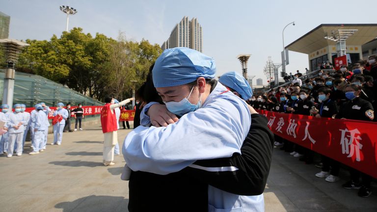 A Wuhan doctor hugs a medic from Jiangsu as he leaves after helping in the city&#39;s hospitals