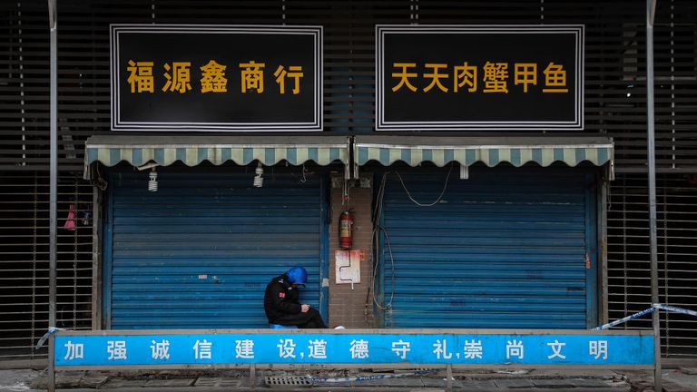 WUHAN, CHINA - JANUARY 17: (CHINA OUT) A security guard sits outside the closed Huanan Seafood Wholesale Market, which has been linked to cases of Coronavirus, on January 17, 2020 in Wuhan, Hubei province, China. Local authorities have confirmed that a second person in the city has died of a pneumonia-like virus since the outbreak started in December. (Photo by Getty Images)