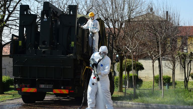 BERGAMO, ITALY - APRIL 02:  An Italian soldier sanitizes the exterior of the Carlo Giovanni Rota retirement home for the elderly in Almenno San Salvatore on April 2, 2020 in Bergamo, Italy. The government of the Russian Federation has sent medical equipment, mobile laboratories and disinfection units, doctors and even military experts in a bacteriological warfare to help the Italian military in the areas most affected by the coronavirus outbreak. The Italian government continues to enforce the nationwide lockdown measures to control the spread of COVID-19.  (Photo by Pier Marco Tacca/Getty Images)