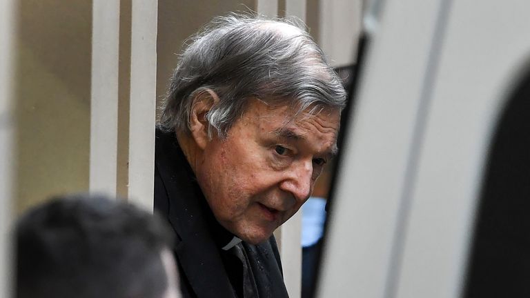Australian Cardinal George Pell (C) is escorted in handcuffs from the Supreme Court of Victoria in Melbourne on August 21, 2019. - Disgraced Catholic Cardinal George Pell was sent back to jail after an Australian court rejected his landmark appeal against convictions for child sex abuse. (Photo by William WEST / AFP)        (Photo credit should read WILLIAM WEST/AFP via Getty Images)
