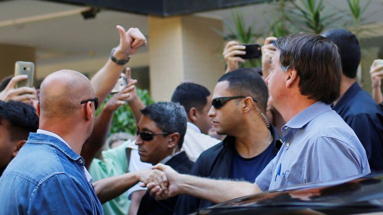 Brazil's President Jair Bolsonaro greets supporters in a neighborhood Sudoeste, amid the coronavirus disease (COVID-19) outbreak, in Brasilia, Brazil, April 10, 2020. REUTERS/Adriano Machado