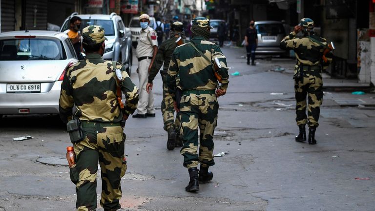 Border Security Force personnel (BSF) patrol a deserted street during a government-imposed nationwide lockdown as a preventive measure against the spread of the COVID-19 coronavirus, in the old quarters of New Delhi on April 25, 2020. (Photo by SAJJAD  HUSSAIN / AFP) (Photo by SAJJAD  HUSSAIN/AFP via Getty Images)