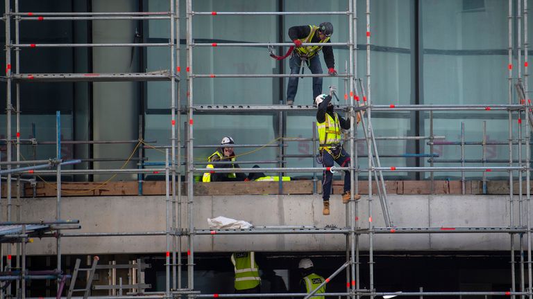 Construction workers on a residential building in Canary Wharf, after Prime Minister Boris Johnson has put the UK in lockdown to help curb the spread of the coronavirus.